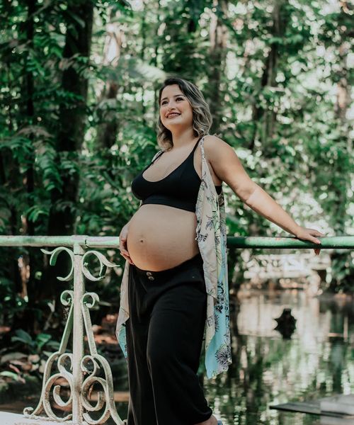 Portrait of a smiling woman mentor in a calm, natural setting.